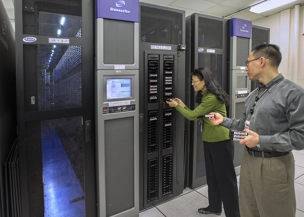 man and woman in front of server rack